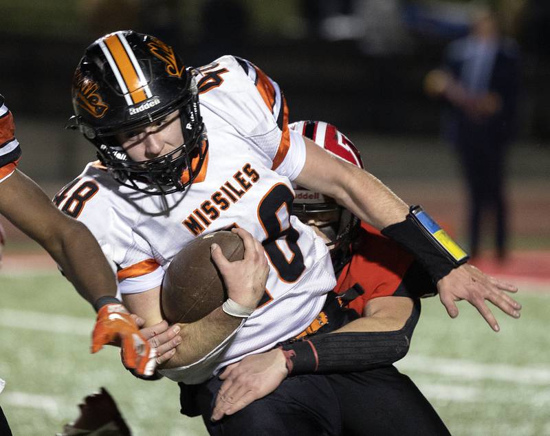 Milledgeville’s Karter Livengood is tackled by Amboy’s Brayden Klein Friday, Nov. 22, 2024, during the 8-man football championship in Monmouth.