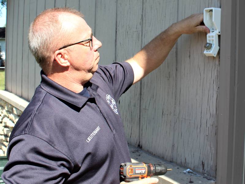 DeKalb Fire Prevention Officer Tom Conley installing a Knox Home Box on Wednesday, June 29. The home is the first to be loaned a Knox Home Box through the DeKalb Fire Department’s Knox Home Box program.