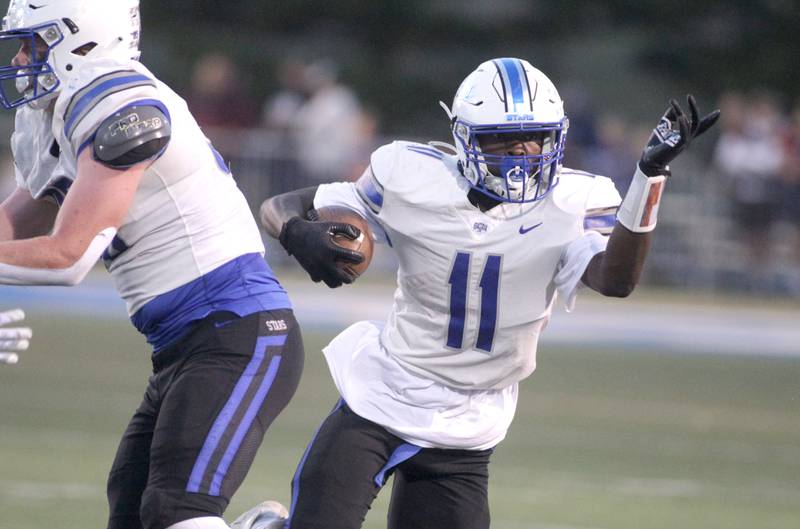 St. Charles North’s Joell Holloman runs the ball during a game at Wheaton North on Friday, Sept. 8, 2023.