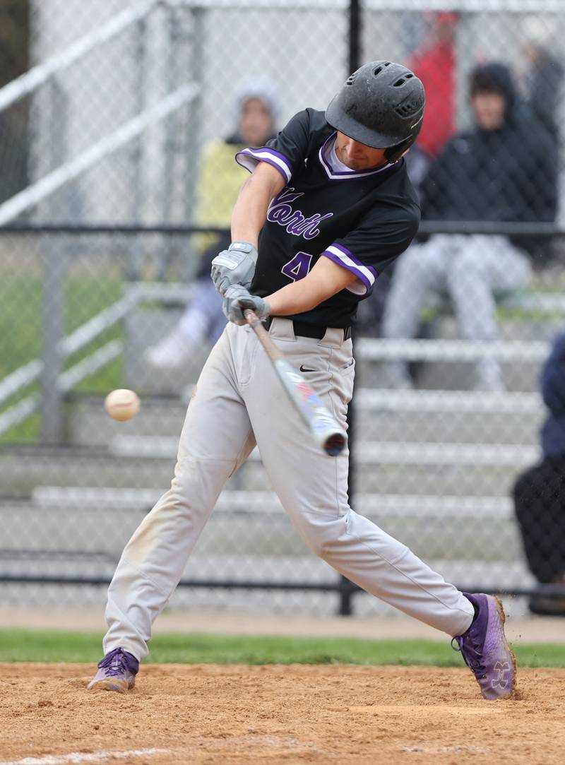 Downers Grove North's Joseph Chiarelli (4) hits the ball during the varsity baseball game between Downers Grove South and Downers Grove North in Downers Grove on Saturday, April 29, 2023.