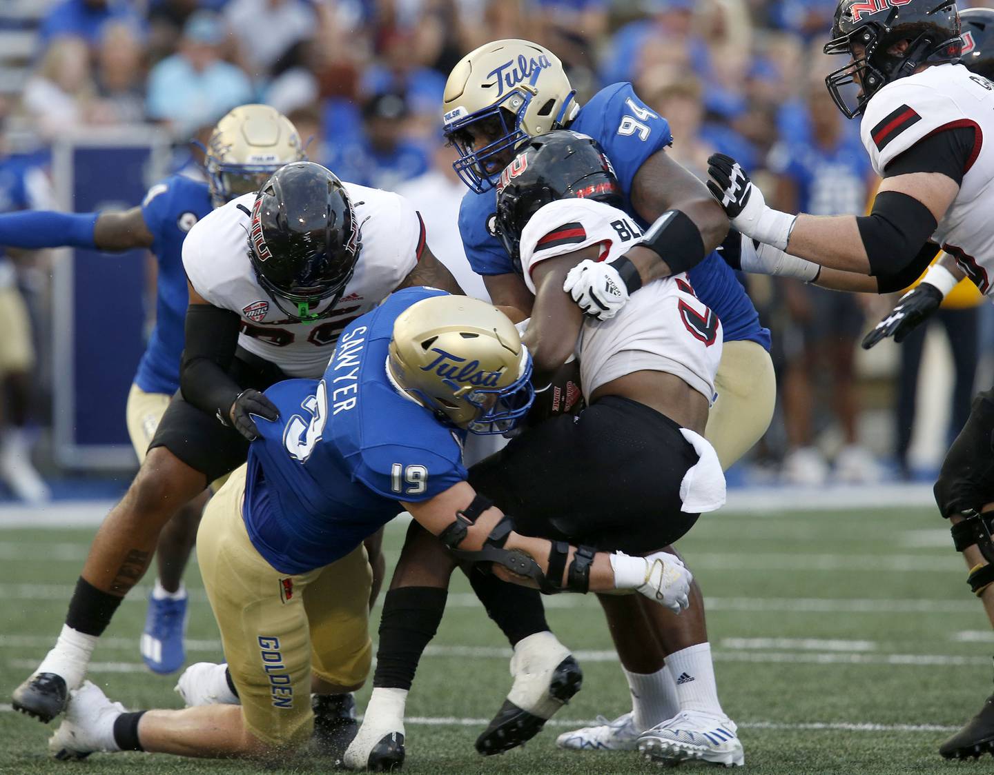 Tulsa's Grant Sawyer and Anthony Goodlow tackle Northern Illinois' Mason Blakemore during an NCAA college football game Saturday, Sept. 10, 2022, in Tulsa, Okla. (Stephen Pingry/Tulsa World via AP)