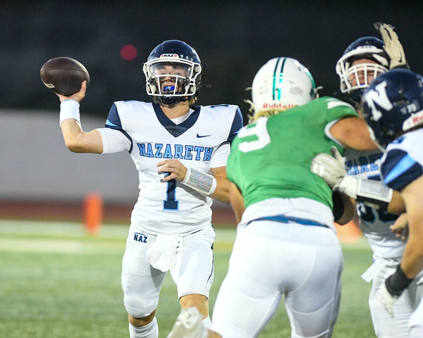 Nazareth Academy’s Cash Coleman (1) tries a passing the ball during the first quarter while traveling to take on York High School in Elmhurst.