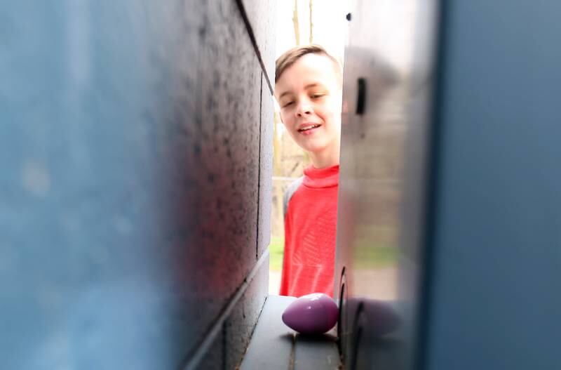 Aiden Kurrle of Utica, finds an unusual Easter egg hidden behind a meter box during the annual Easter egg hunt on Saturday, April 19, 225 at Carey Memorial Park in Utica.