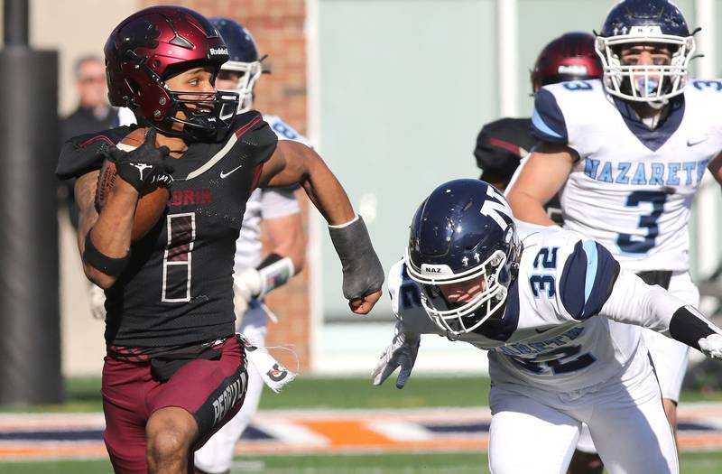 Peoria's Ricky Hearn gets past Nazareth's Finn O'Meara during a kickoff return during their IHSA Class 5A state championship game Saturday, Nov. 26, 2022, in Memorial Stadium at the University of Illinois in Champaign.