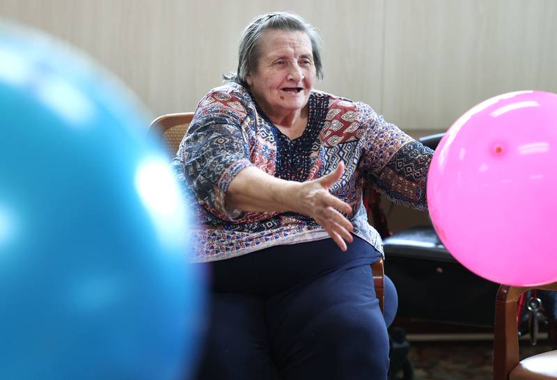 Barb City Manor resident Jean Wiser makes a catch during an activity Tuesday, July 2, 2024, at the retirement home in DeKalb. Barb City Manor celebrated its 45th anniversary earlier this year.