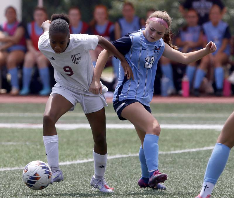St. Ignatius College Prep's Sloan Williams battles with Nazareth Academy's Lucy Gergits for control of the ball during a IHSA Class 2A State Girls Soccer semifinal match on Friday, June 6, 2025, at North Central College in Naperville.