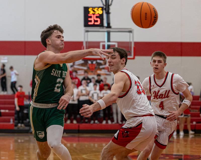 St. Bede's Gus Burr (2) throws ball to teammate as Braden Curran (33) of Hall and teammate Luke Bryant (4) watch on Saturday, January 31, 2026 at Hall High School in Spring Valley.