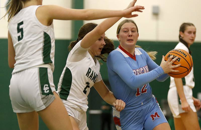 Marian Central's Abbey Miner (right) drives the lane against Grayslake Central's Mosey Drevline (center) and Katie Marcelain (left) during a nonconference girls basketball on Monday, Jan. 13, 2025, at Grayslake Central High School.