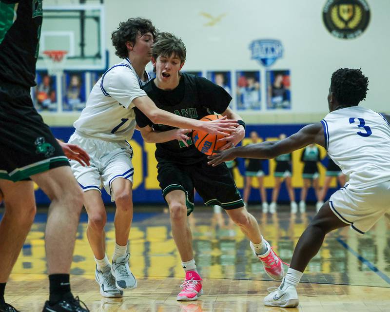 Hayden Spoonmore (2) of Leland dribbles ball down lane as Austin Reibel (1) of Newark reaches across body during the quarterfinals of the Little Ten Conference Tournament on Monday, Feb. 2, 2026 at Somonauk High School in Somonauk.