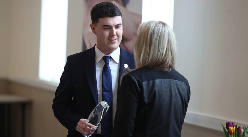 Andrew Miller, branch manager at Old National Bank, accepts the Outstanding Business Award on behalf of the bank Thursday, March 5, 2026, during the Sycamore Chamber of Commerce Annual Meeting in Memorial Hall at St. Mary's Catholic Church in Sycamore.