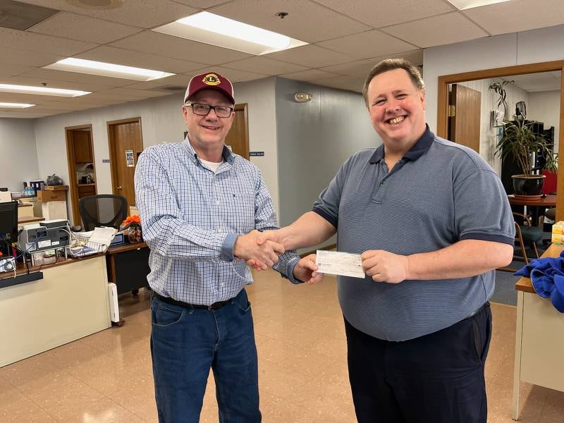 Streator Unlimited Executive Director John Malaney (right) receives a $2,000 check from Hardscrabble Lions President David Reed.