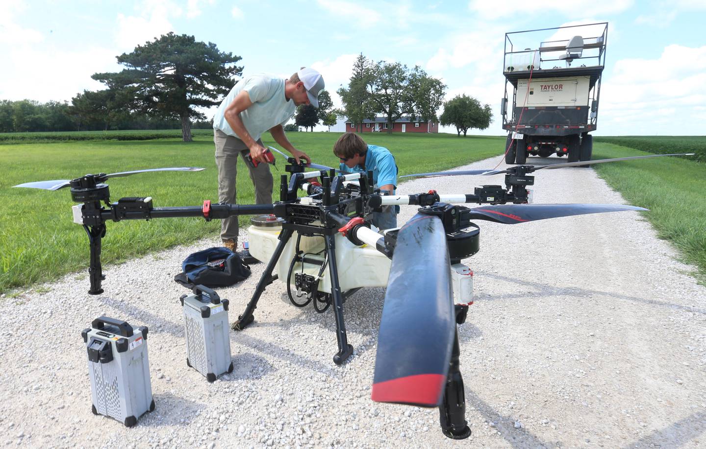 Silas Steiner owner of Thrive spray drone service and Christian Miller pilot, perform routine maintenance on a DJI XAG P150 drone while spraying an application on Monday, July 28, 2025 near Wenona. The drone weighs a little over 100 lbs empty but can weigh as much as 250 pounds. 
The 18.5 gallon liquid spray tank can be equipped with a broadcast spreader hopper that can hold up to 150 pounds of dry material. The drone can cover up to 9 acres on a single tank of liquid and up to 55 acres an hour in perfect conditions. "We use these drones for spraying all types of pesticides including, herbicides, fungicides, insecticides, and nutritional/fertilizer products. We also use these drones to spread dry products such as small seeds and cover crops," said Steiner.