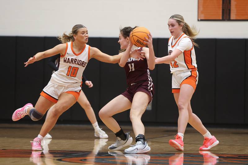 Lincoln-Way West’s Molly Finn (10) and Reagan McCracken (42) force a turnover against Lockport’s Laura Arstikaitis on Tuesday, Feb. 3, 2026 in New Lenox.