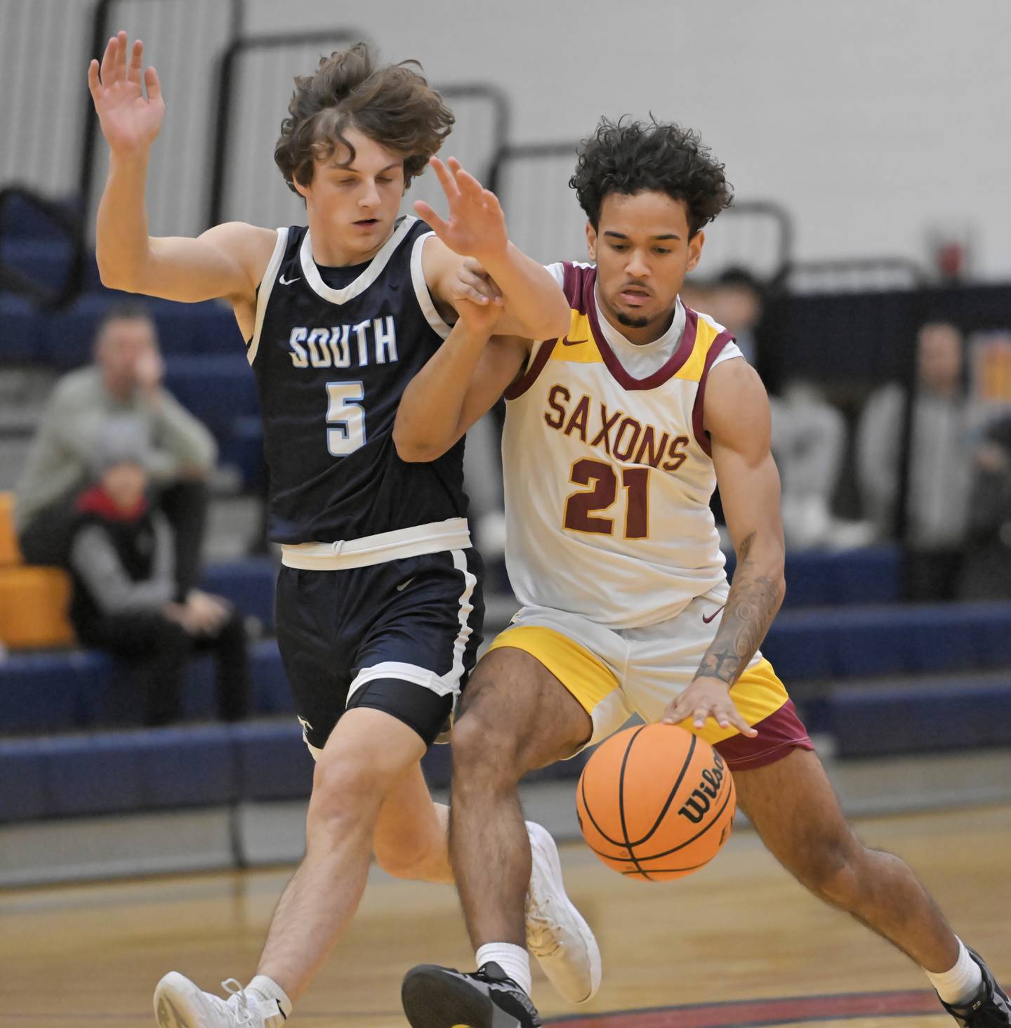 Schaumburg’s Jordan Tunis tries to get past Downers Grove South’s Wyatt Wawro in a boys basketball game in Buffalo Grove on Friday, January 3, 2025.