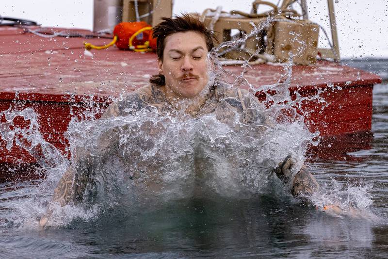 One of the participants of the plunge impacts the icy water during the Make-A-Wish Illinois Penguin Plunge on  January 31, 2026 at Skydive Chicago.