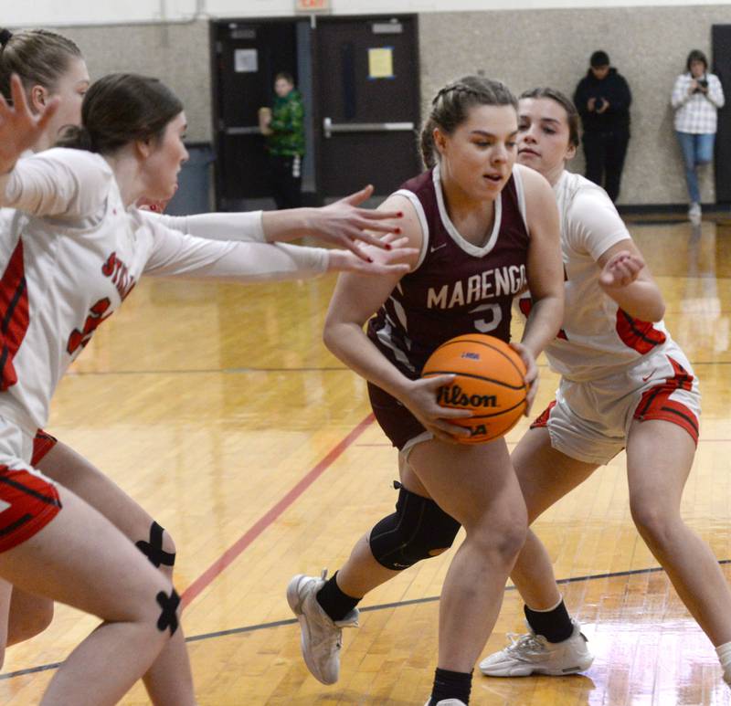 Marengo's Emilie Polizzi draws a trio of Stillman Valley defenders as she drives to the basket during the 2A Stillman Valley Regional on Monday, Feb. 17, 2025 at Stillman Valley High School. The Cardinals won the game 58-31 to advance to the sectional final on Thursday, Feb. 20, 2025. Polizzi led Marengo in scoring with nine points.
