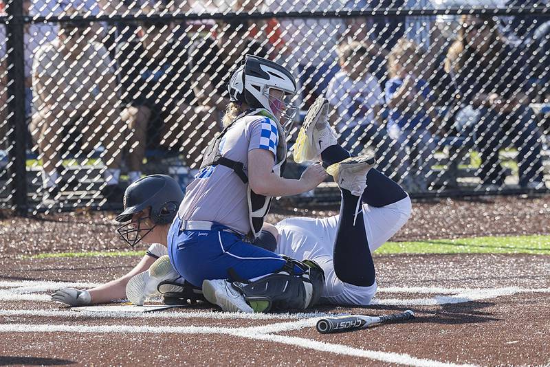 Sterling’s Carley Sullivan is tagged out at home by Newman’s Carlin Brady Thursday, April 27, 2023.