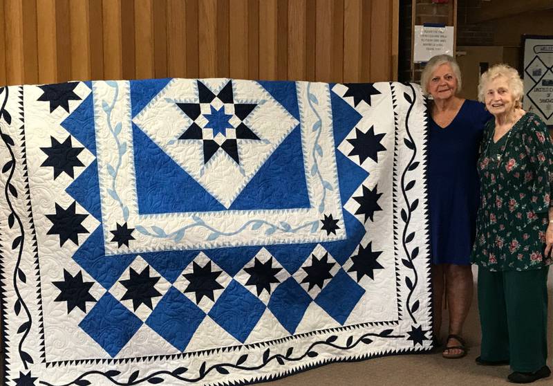 Pictured is last years quilt winner, Sandy Whiteis, with quilt maker Vivian McMaster.