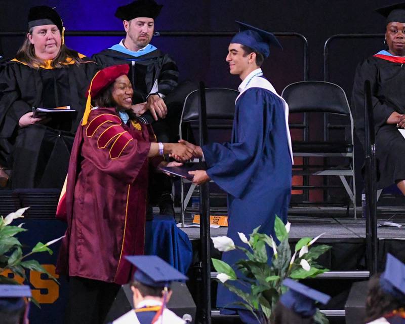 Oswego High School senior Owen Dougherty is all smiles as he receives his diploma on Saturday May 17, 2025, during the graduation Ceremony held at the Convocation Center in DeKalb