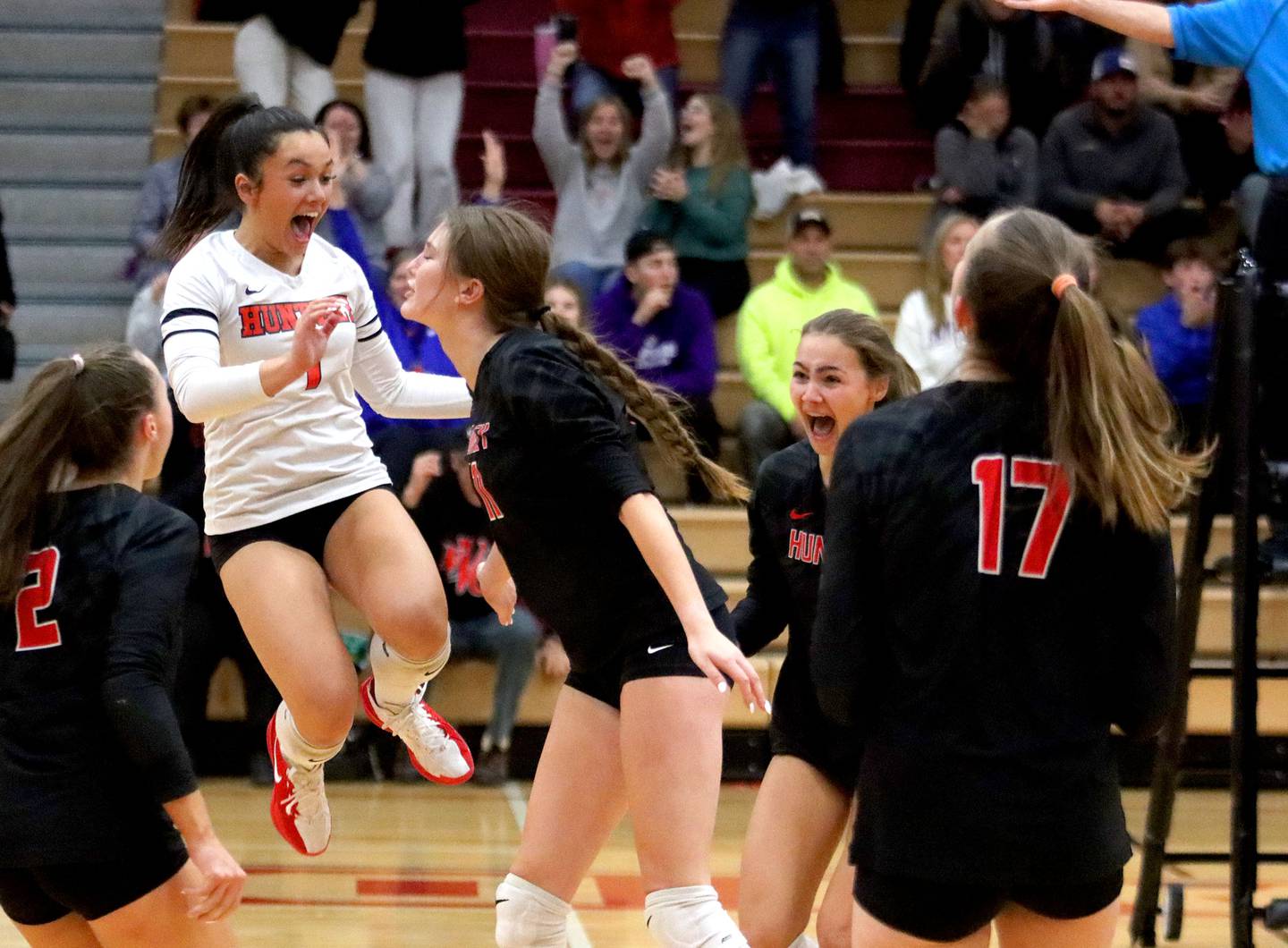 Huntley’s Red Raiders celebrate a point against  Hampshire in girls varsity volleyball at Huntley High School on Thursday, October 23, 2025. The Red Raiders fell in three sets to Hampshire.