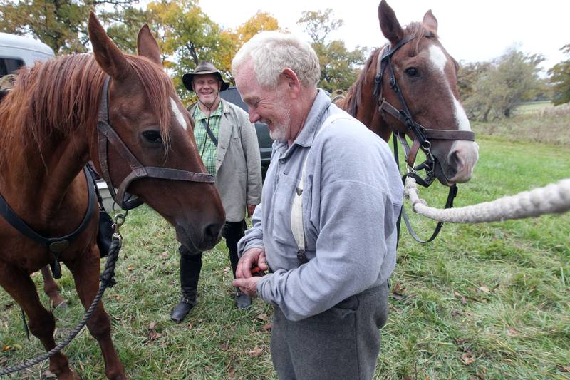 Kevin Wright, of Kankakee shares a laugh with Larry Powell, of Forest View, both with the 3rd Tennessee Calvary, as he feeds a carrot to his horse during Hainesville’s Civil War Encampment & Battle at the Northbrook Sports Club on October 21st in Hainesville. 
Photo by Candace H. Johnson for Shaw Local News Network