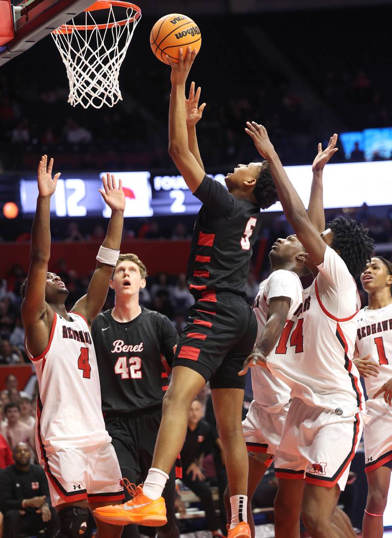 Benet's Perry Tchiegne shoots over Marist's Karson Thomas Saturday, March 14, 2026, during their IHSA Class 4A state championship game in the State Farm Center at the University of Illinois in Champaign.