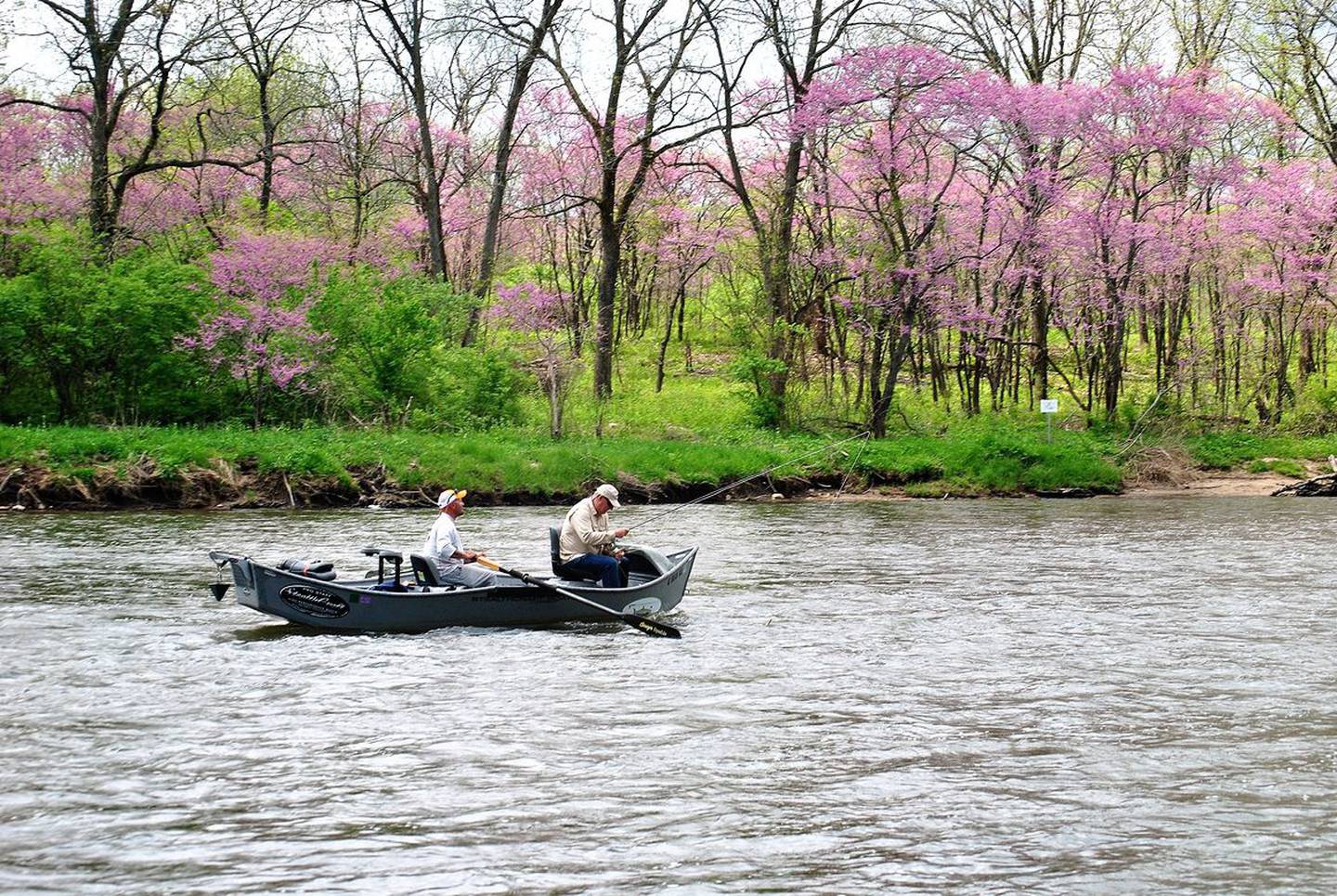 Two fisherman navigate the Kankakee River near the Kankakee River State Park.