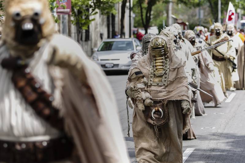 A line of Tusken Raiders marches in the parade during the Joliet Public Library's fifth annual Star Wars Day on Saturday, June 7, 2014.
