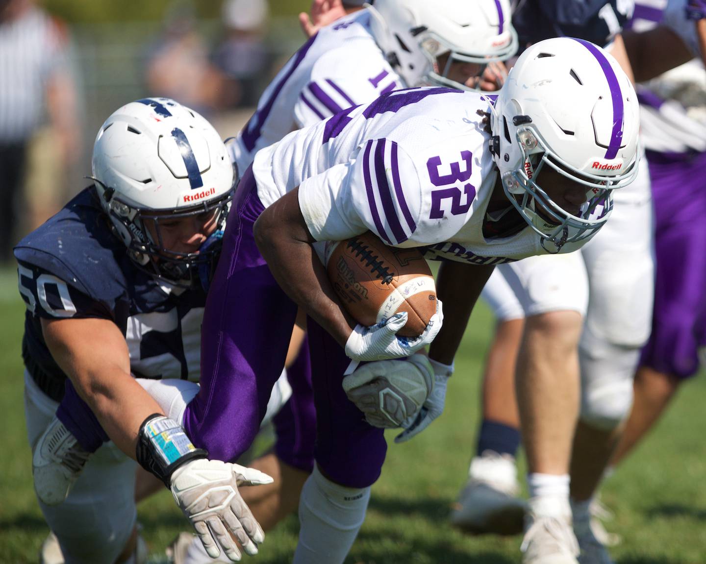 Cary Grove's Ty Drayton tackles Hampshire's Tymere on Saturday Oct. 5,2024 in Cary.
