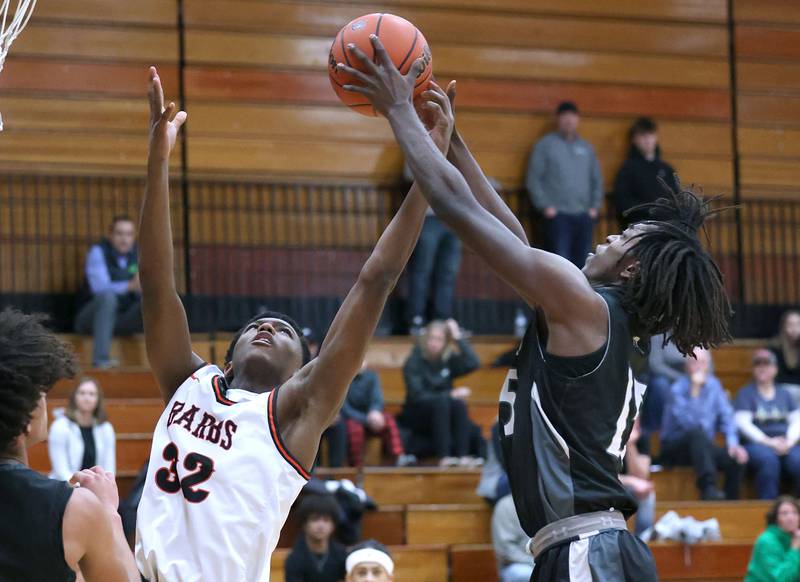 DeKalb’s Justin O’Neal and Kaneland's Freddy Hassan go after a rebound during their game Monday, Feb. 12, 2024, at Huntley Middle School in DeKalb.