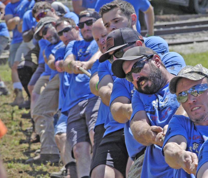 Tuggers from  Knapps Contracting and Storage pull the Iowa team as part of the Port Byron hosted Great River Tug Fest across the Mississippi on Saturday, August 10, 2024.