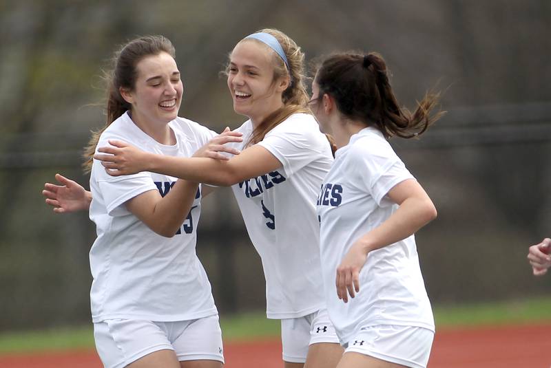 Oswego East’s Anya Gulbrandsen (center) celebrates her goal with her teammates during a Naperville Invitational game against St. Charles North at Naperville Central on Saturday, April 23, 2022.