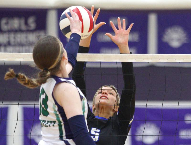 Burlington Central’s Emily Maramba blocks against Bartlett’s Sam Buss, left, in varsity volleyball tournament action on Saturday, Sept. 21, 2024, at Hampshire High School in Hampshire.