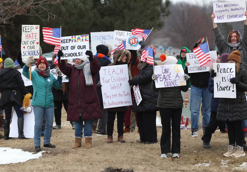 Protesters hold signs Thursday, Feb. 5, 2026, in front of Genoa-Kingston High School. The group is protesting the “History Rocks” assembly which is part of a nationwide campaign by the U.S Department of Education tied to the nation’s 250th anniversary and organized by the high school’s Turning Point USA, Club America chapter, a nonprofit founded in 2012 by the late Charlie Kirk.