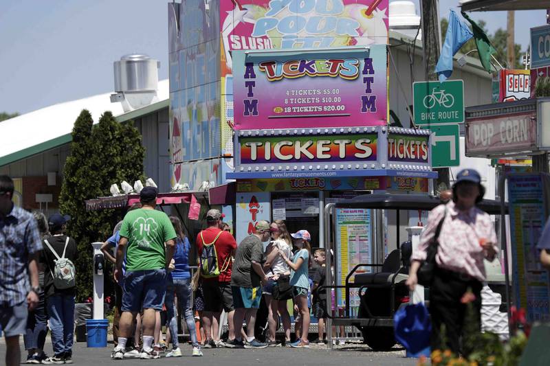 A line of people wait to purchase tickets during opening day of Ribfest Friday June 17, 2022 at the DuPage County Fairgrounds in Wheaton. After 32 years in Naperville and then a pandemic pause, Ribfest has moved to the DuPage County Fairgrounds in Wheaton. The four-day event will be held over Father's Day weekend, just like the very first Ribfest in 1987.