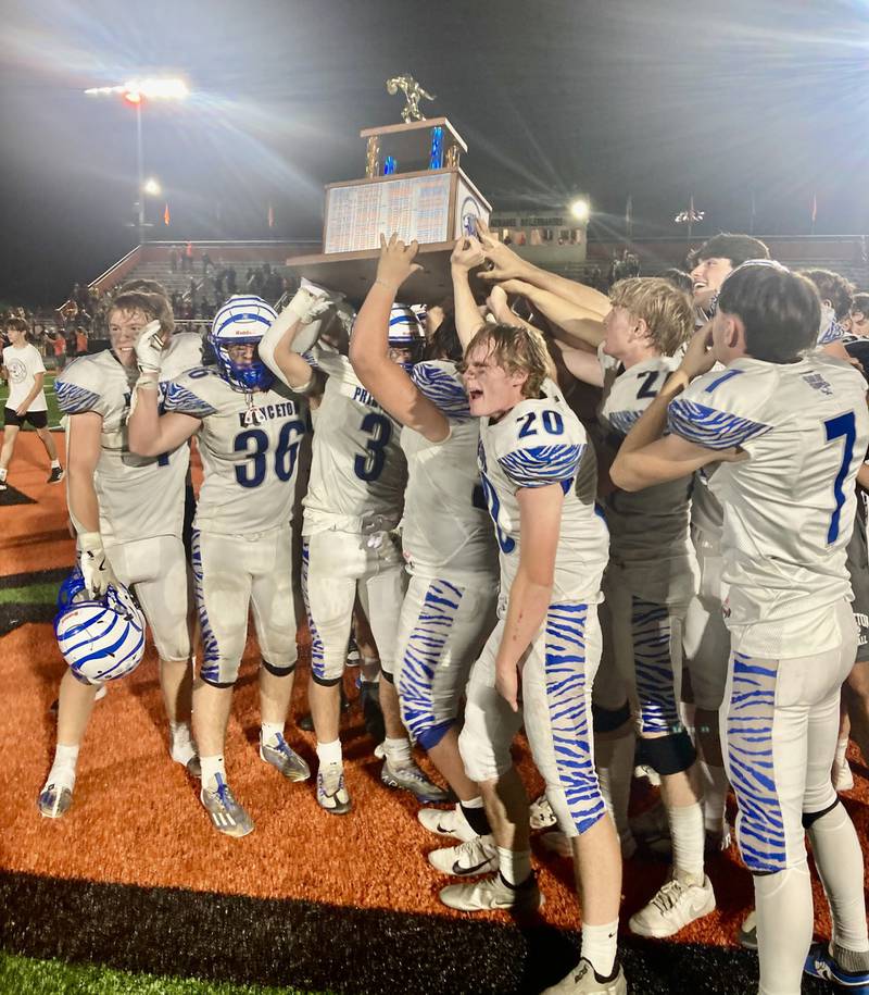 The Princeton Tigers hoist the traveling trophy that goes with their victory over rival Kewanee Friday night. The Tigers defeated the Boilermakers 44-15 in their 126th meeting, now leading the all-time series 65-57-4.