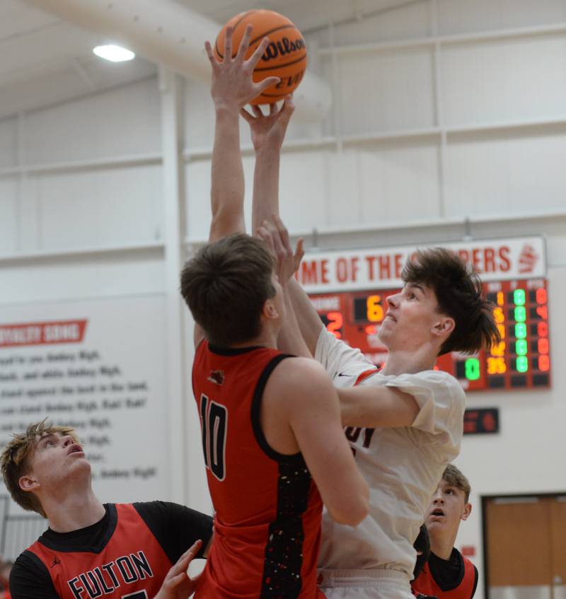 Amboy's Ezra Parker (21) shoots as Fulton's Landen Leu (10) defends during a Friday, Jan. 17, 2025 game at Amboy High School.