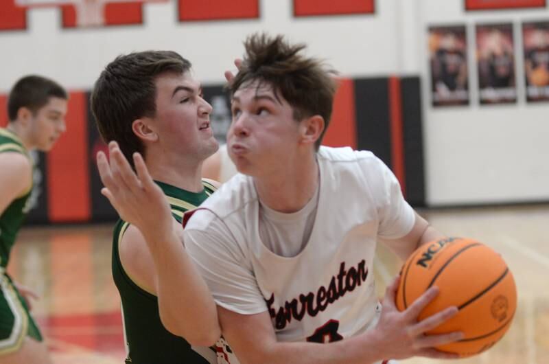Forreston's Brendan Greenfield makes a move to the basket against Peru St. Bede's  Haden Hueneburg on Wednesday, Feb. 26, 2025 at the 1A Amboy Regional.