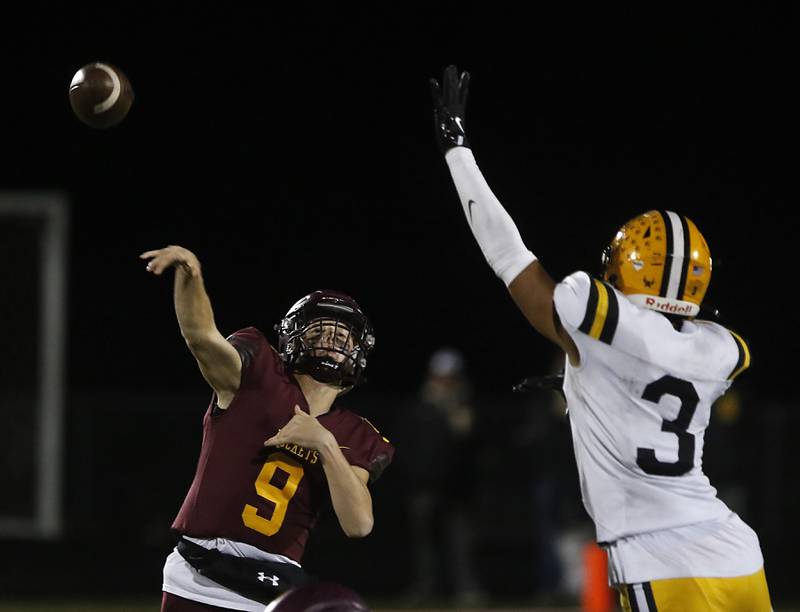 Richmond-Burton's Ray Hannemann throws a pass and St. Laurence's Sean Rice rushes during an IHSA Class 4A first-round football game on Friday, Nov. 1, 2024, at Richmond-Burton High School in Richmond.