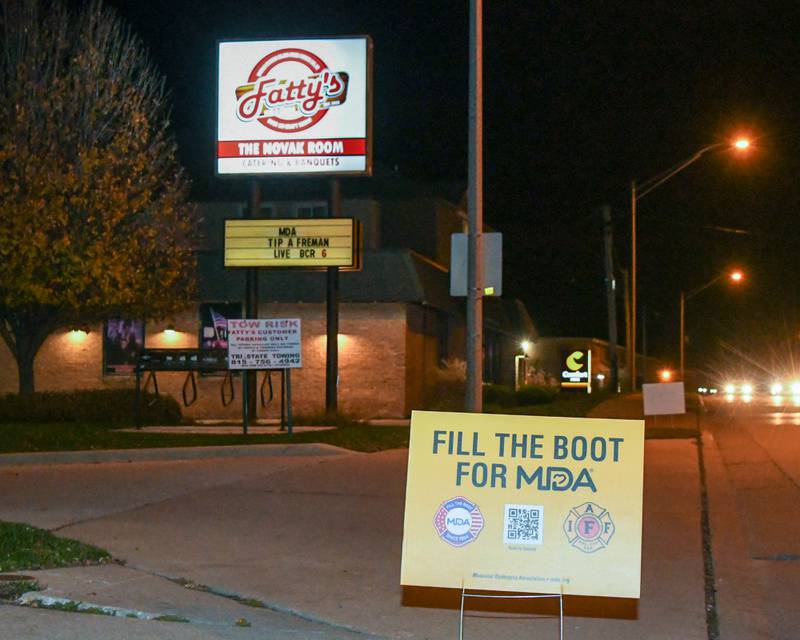 Signs advertise the DeKalb Fire Department's annual charitable event on Wednesday, Nov. 27, 2024, outside Fatty's Pub and Grille in DeKalb during the DeKalb Fire Fighters Local 1236 union's Tip A Firefighter event to fundraise for the Muscular Dystrophy Association.