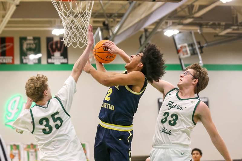 Bishop Mcnamara's Callaghan O'Connor (33) blocks a shot attempt by Yorkville Christian's Kayden Maxwell (2) during their Class 2A Seneca Sectional final basketball game between Bishop McNamara at Yorkville Christian, March 6, 2026 in Senaca.
