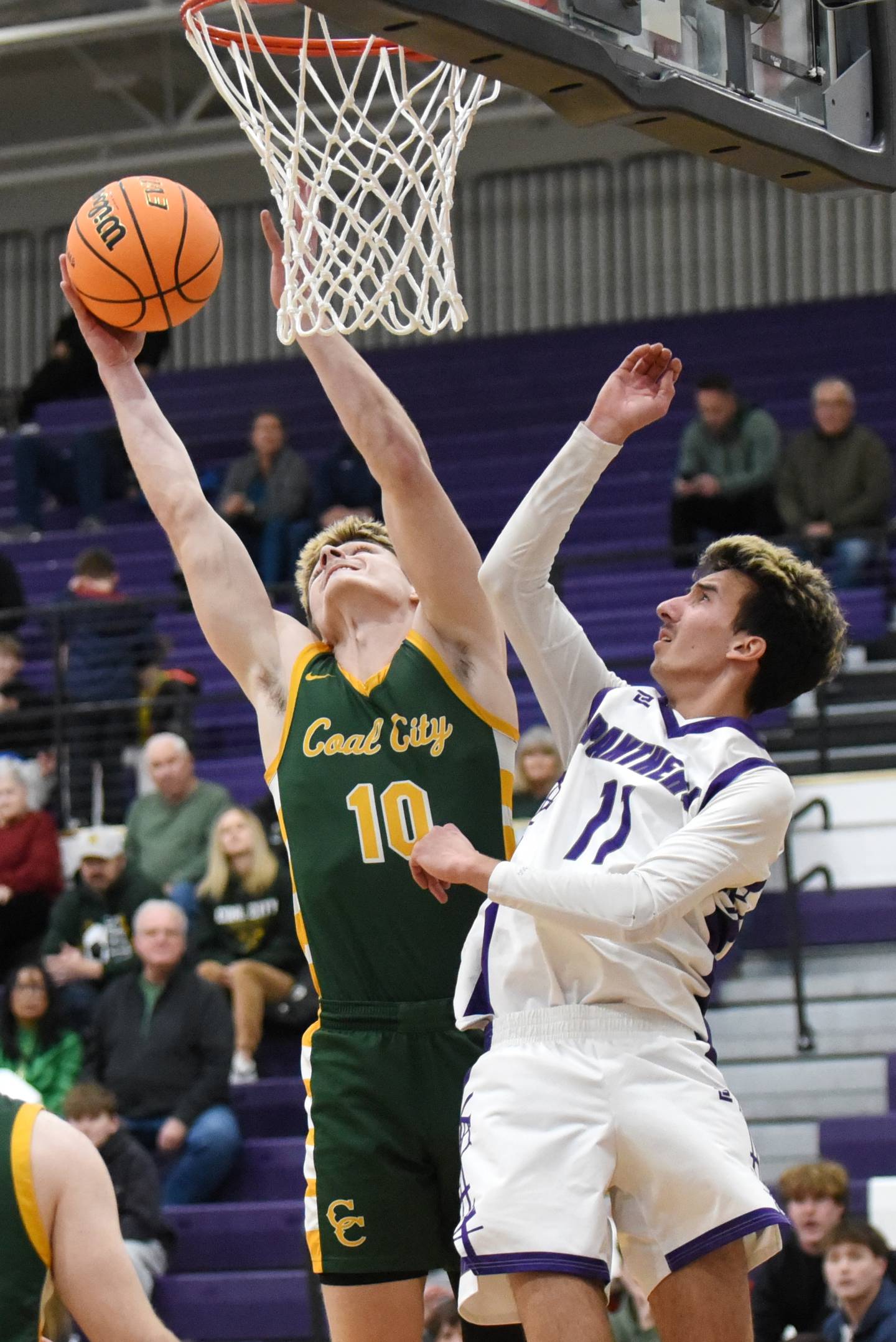 Coal City's Parker Jacovec, left, grabs a rebound over Manteno's Braden Campbell during the IHSA Class 2A Manteno Regional quarterfinals Monday, Feb. 23, 2026.