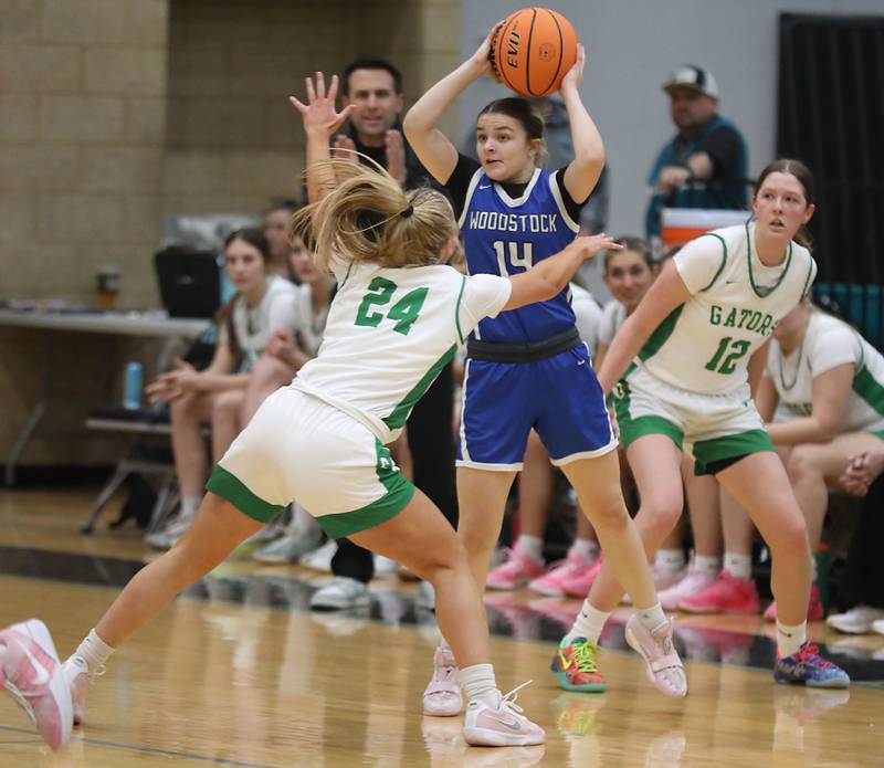 Woodstock's Reese Zawisza looks to pass as is double teamed by Crystal Lake South's Gracey LePage (left) and Gaby Dzik (right) during the IHSA Class 3A Woodstock North Regional championship girls basketball game on Thursday, Feb. 19, 2026, at Woodstock North High School.