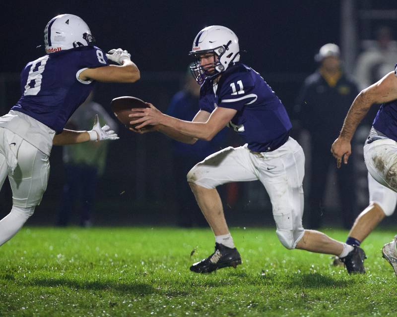 Cary - Grove's Peyton Seaburg hands the ball off to Andrew Prio against Crystal Lake South on Friday, Oct. 13 2023 in Cary Grove.