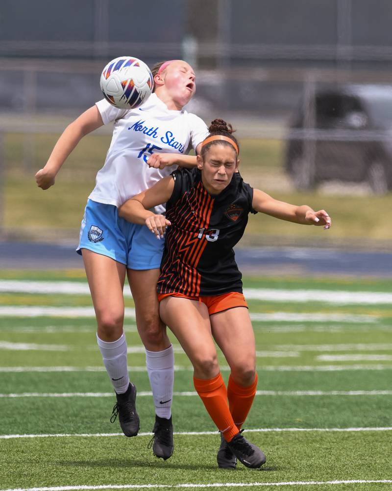 St. Charles North Lauren Balster (15) and St. Charles East Georggia Desario (13) trie to go up to head the ball in the first half of the sectional title game on Saturday May 27th held at West Chicago Community High School.