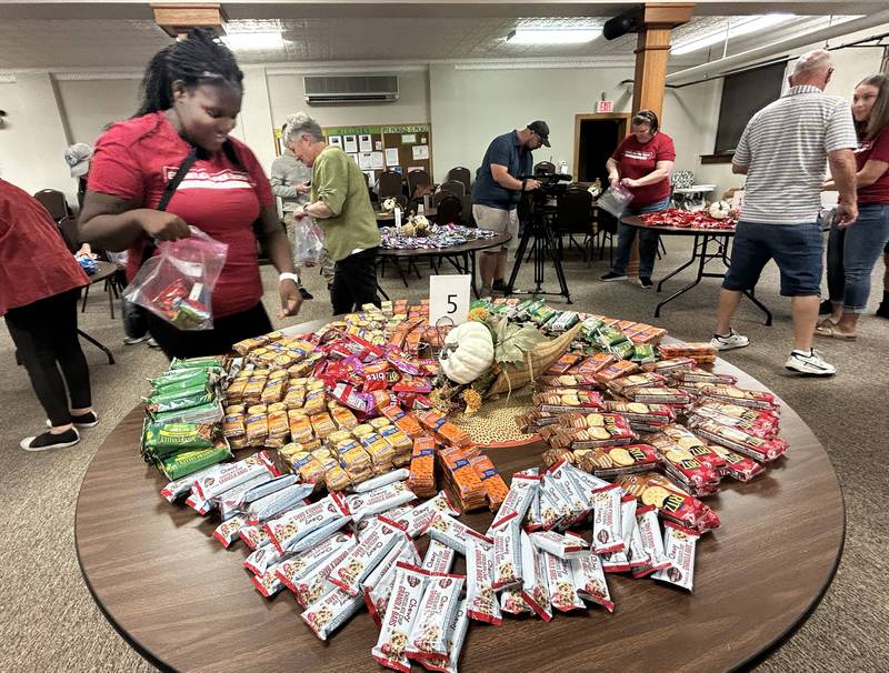 Catherine Bloemker (left) was one of the volunteers at the Evangelical Free Church of Mt. Morris who helped assemble care packages for sailors on the USS Fitzgerald on Thursday, Oct. 16, 2025.