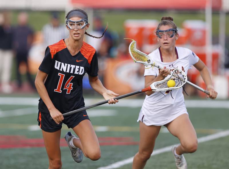 Crystal Lake Central Coop's Addie Bechler (14) looks for an outlet during the lacrosse state semi-final match between Crystal Lake Central and Loyola Academy on Thursday, June 5, 2025 in Hinsdale.