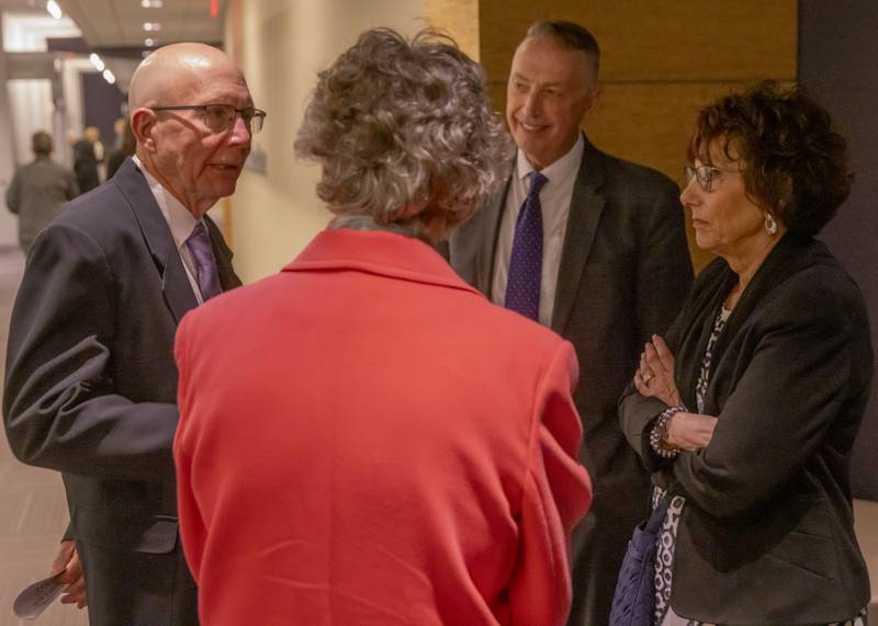 Previous Illinois Valley Community College President, Dr. Jerry Corcoran (left) converses with event attendees of the one hundredth anniversary celebration of Illinois Valley Community College on April 25, 2024.