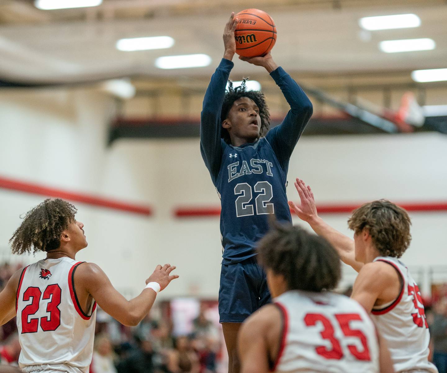 Oswego East's Jehvion Starwood (22) shoots the ball in traffic against three Yorkville defenders during a basketball game at Yorkville High School on Friday, Feb 3, 2023.