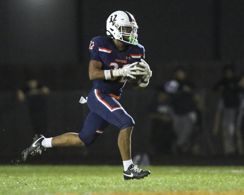 Oswego's Quinten Jackson Jr (32) runs back an interception to ice the game between Oswego East at Oswego Friday, Oct 17, 2025 in Oswego.